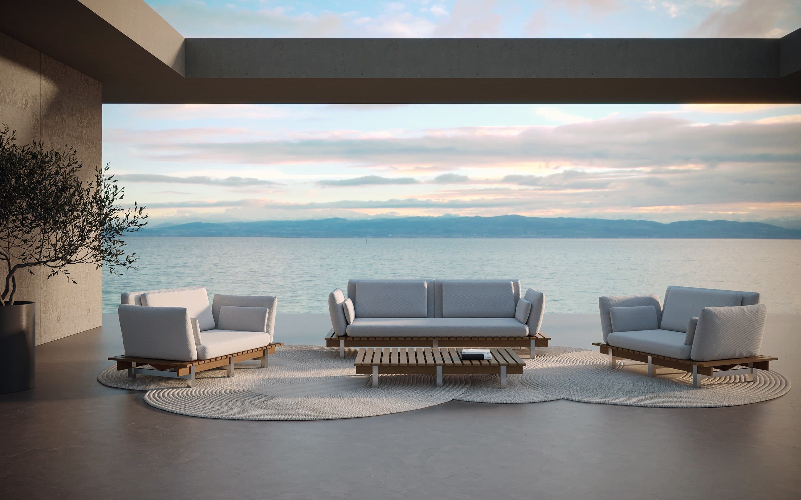 Living exterior con sofás y mesa baja sobre piso de piedra